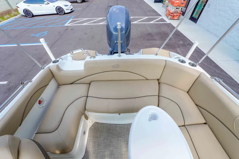 Slide: The Image of 2020 NauticStar 203 DC boat interior with beige seating and a white table. - 14