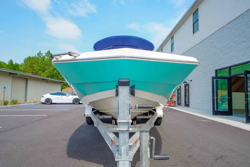 Slide: The Image of 2020 NauticStar 203 DC boat on trailer in parking lot, near buildings. - 9