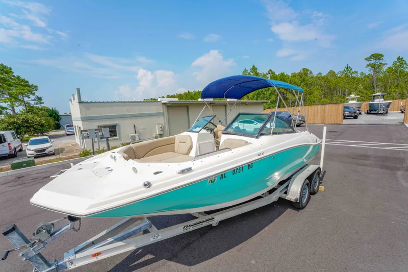 Slide: The Image of 2020 NauticStar 203 DC boat on trailer with blue canopy in parking lot. - 28