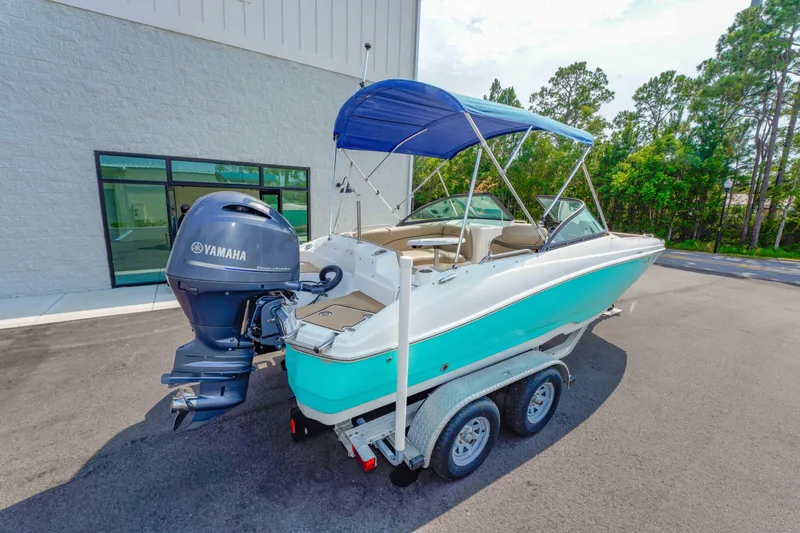 Slide: The Image of 2020 NauticStar 203 DC boat with Yamaha engine on trailer, parked outdoors. - 25