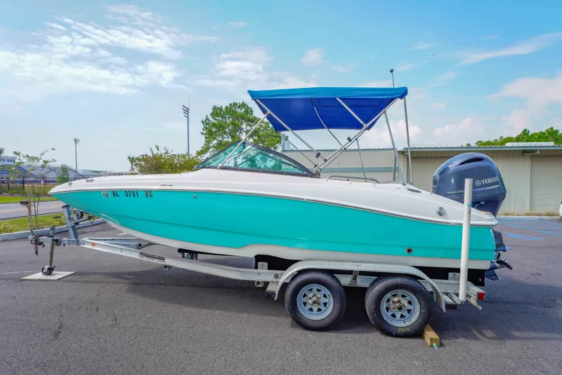 Slide: The Image of 2020 NauticStar 203 DC boat on trailer with blue canopy and Yamaha engine. - 7