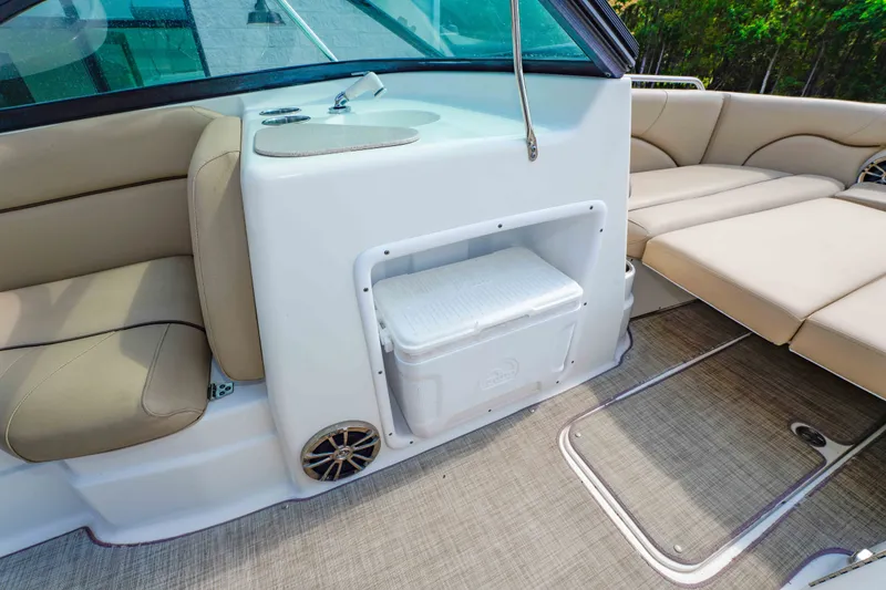 Slide: The Image of Interior of 2020 NauticStar 203 DC boat with beige seating and built-in cooler. - 23