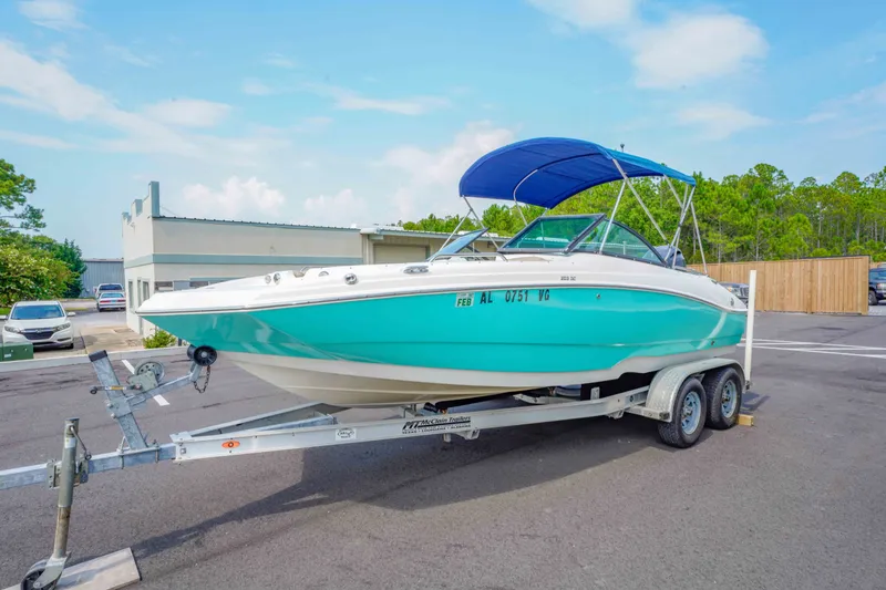 Slide: The Image of 2020 NauticStar 203 DC boat on trailer with blue canopy in parking lot. - 8