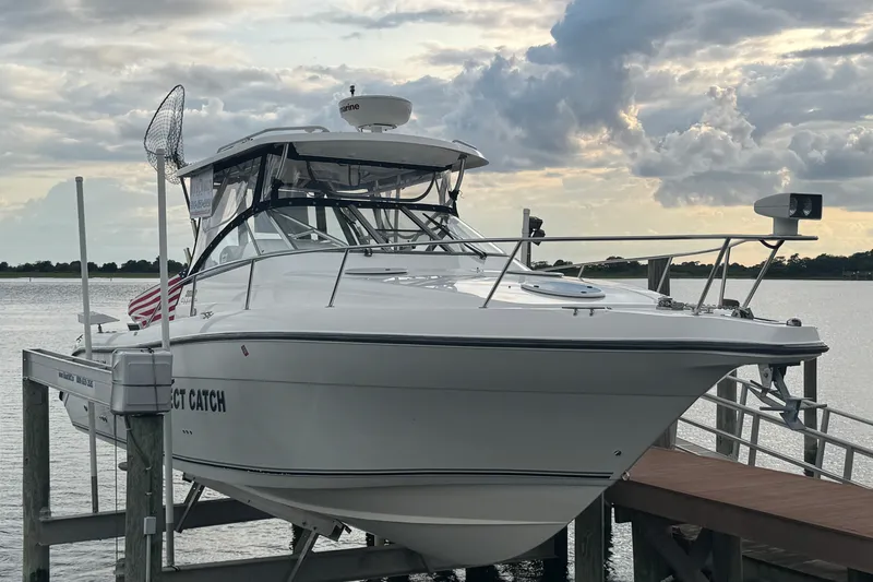 The Image of 2008 Century 3200 Offshore boat docked at sunset with cloudy sky backdrop. - 0