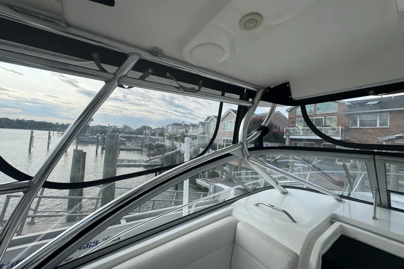 Slide: The Image of Interior view of 2008 Century 3200 Offshore boat with waterfront houses in background. - 7