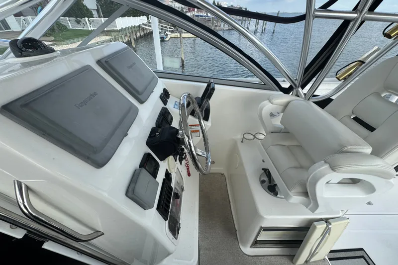Slide: The Image of Cockpit of 2008 Century 3200 Offshore boat with steering wheel and navigation displays. - 19