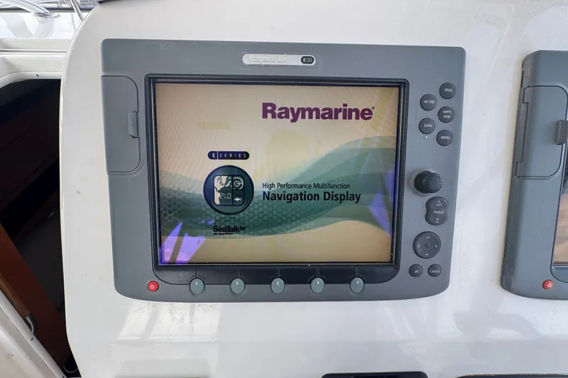 Slide: The Image of Raymarine E120 navigation display on 2008 Century 3200 Offshore boat dashboard. - 14
