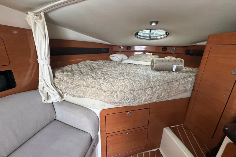 Slide: The Image of Cozy cabin interior of 2008 Century 3200 Offshore boat with bed and seating area. - 20