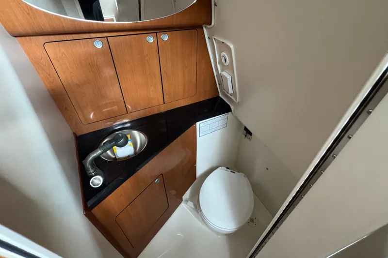 Slide: The Image of Compact bathroom in 2008 Century 3200 Offshore boat with sink and toilet. - 26