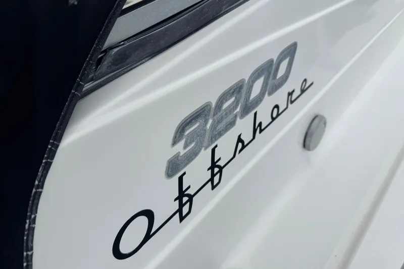 Slide: The Image of Close-up of 2008 Century 3200 Offshore boat logo on white hull. - 32