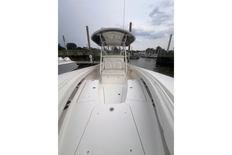 Slide: The Image of 2019 Regulator 28 Forward Seating boat docked, showcasing spacious deck and seating area. - 5