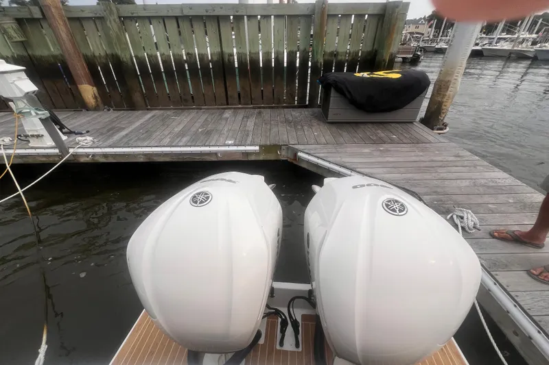 Slide: The Image of Twin Yamaha outboard engines on a 2019 Regulator 28 Forward Seating boat at a dock. - 8