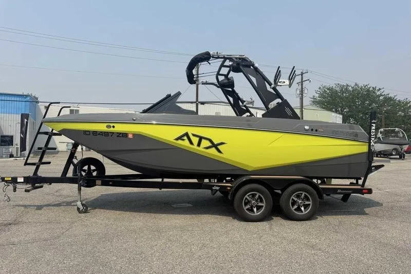 The Image of 2022 ATX Surf Boats 20 Type-S on trailer, vibrant yellow and gray design. - 1