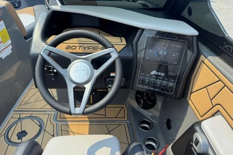 Slide: The Image of 2022 ATX Surf Boats 20 Type-S dashboard with steering wheel and digital display. - 6