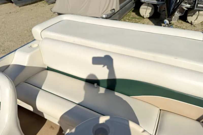 Slide: The Image of 2006 Godfrey Aqua Patio boat seat with shadow on white and green upholstery. - 9
