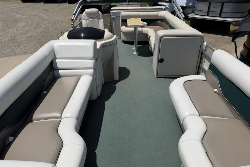 Slide: The Image of 2006 Godfrey Aqua Patio boat interior with spacious seating and table. - 3
