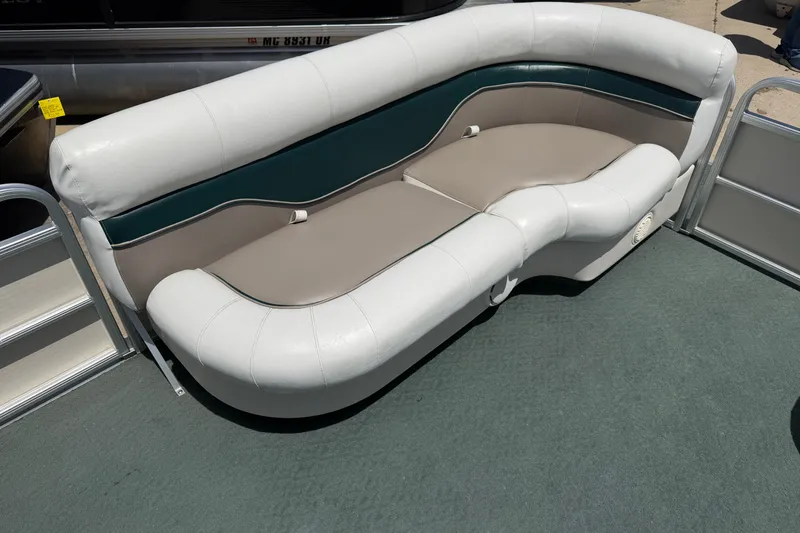 Slide: The Image of A cushioned seating sofa on a boat with white and gray leather upholstery. - 7