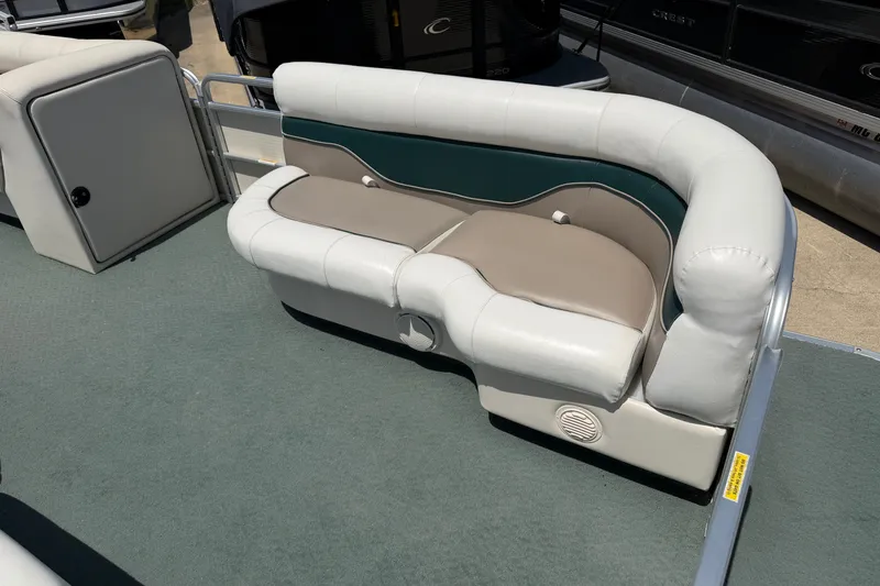 Slide: The Image of 2006 Godfrey Aqua Patio boat seating with white and beige upholstery on deck. - 4