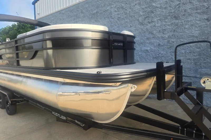 Slide: The Image of 2027 Lowe SS 230 WV pontoon boat on trailer, sleek design, metallic finish. - 4