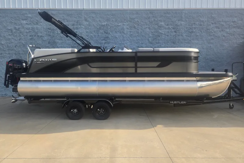The Image of 2027 Lowe SS 230 WV pontoon boat on trailer, sleek design, parked outdoors. - 1