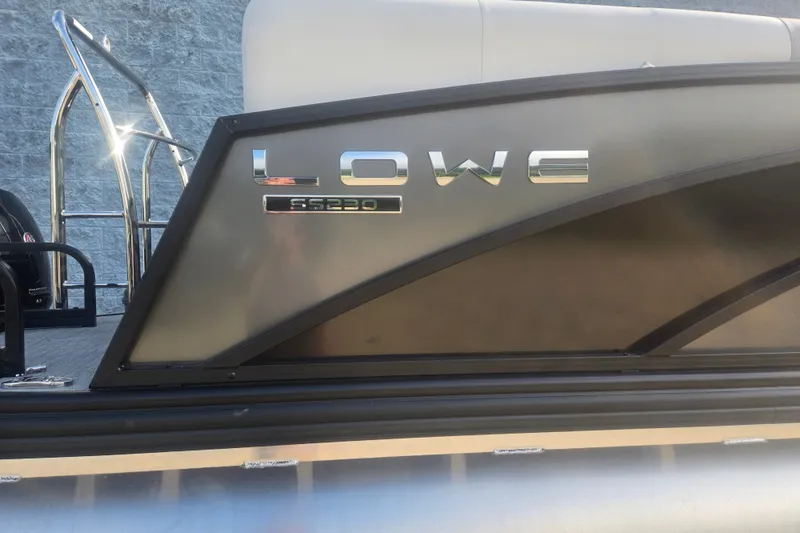Slide: The Image of 2027 Lowe SS 230 WV pontoon boat with sleek design and chrome lettering. - 7