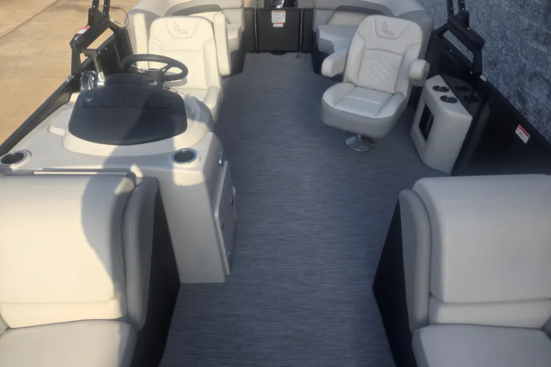 Slide: The Image of The image shows the interior of a 2027 Lowe SS 230 WV pontoon boat with beige seating. - 7