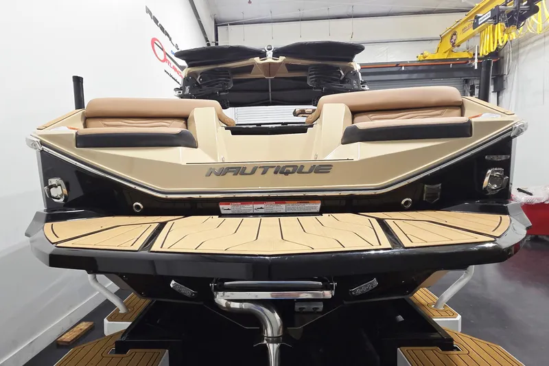 Slide: The Image of 2026 Nautique Super Air Nautique G23 boat rear view in showroom. - 5