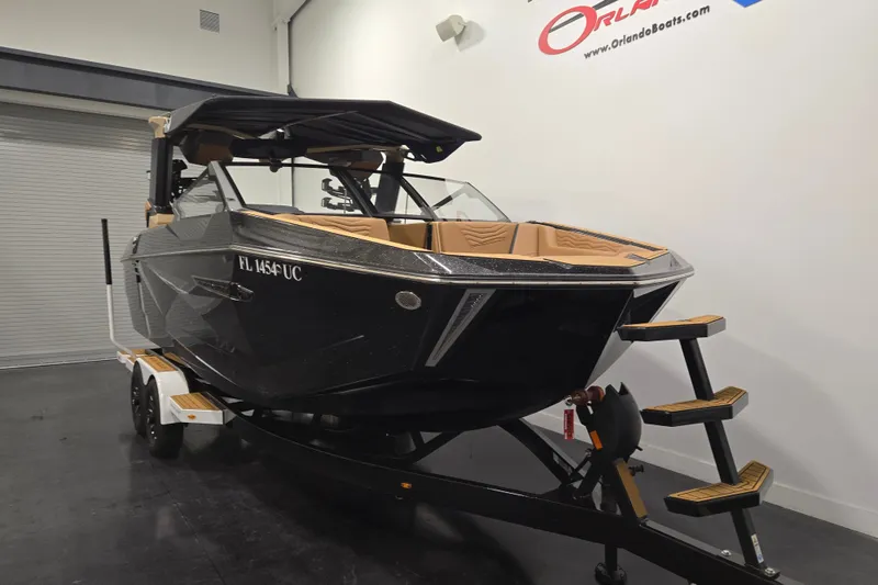Slide: The Image of 2026 Nautique Super Air Nautique G23 boat on trailer in showroom. - 2