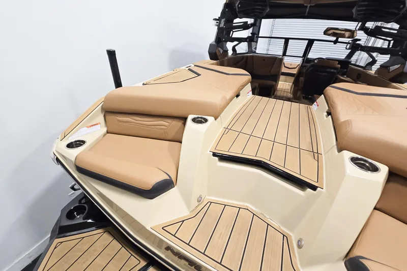 Slide: The Image of 2026 Nautique Super Air Nautique G23 boat interior with tan seating and wood accents. - 6