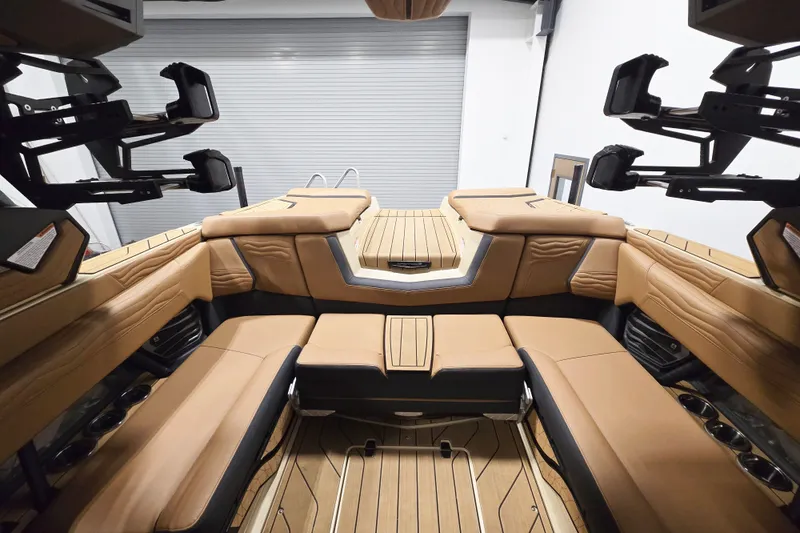Slide: The Image of Luxurious interior of 2026 Nautique Super Air Nautique G23 boat with tan seating. - 11