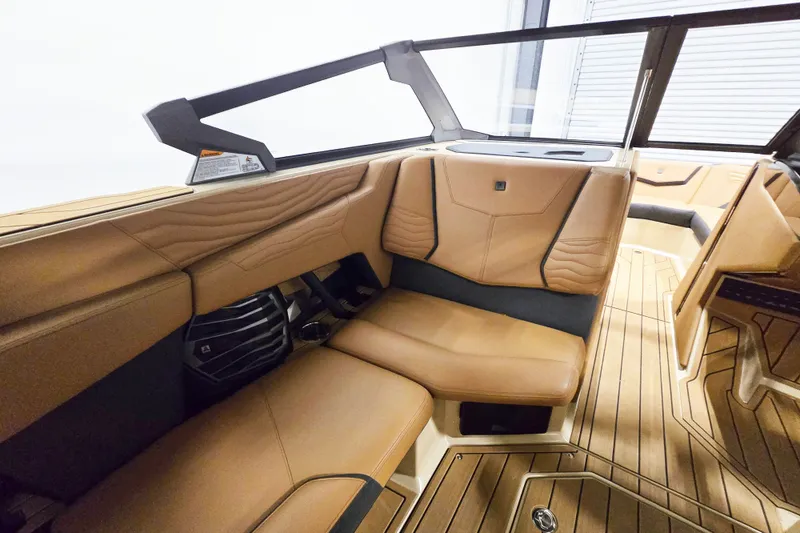 Slide: The Image of 2026 Nautique Super Air Nautique G23 interior with tan leather seating and sleek design. - 8