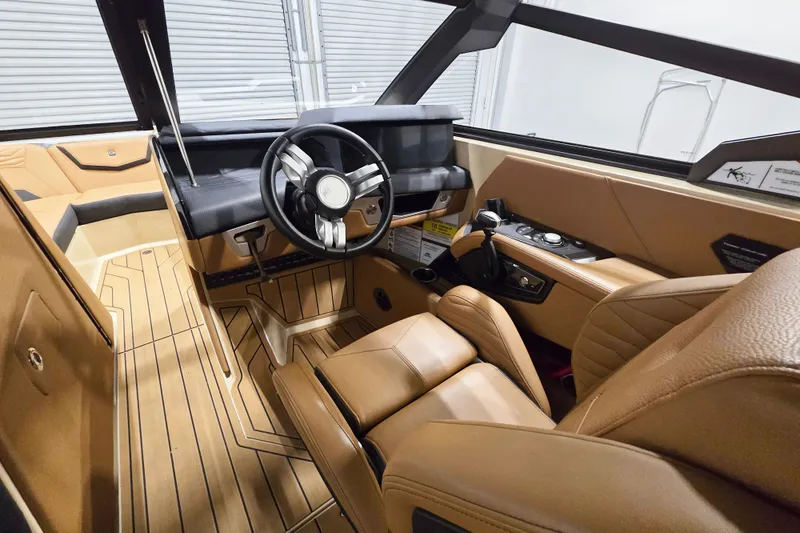 Slide: The Image of Interior of 2026 Nautique Super Air Nautique G23 boat with tan leather seating. - 9