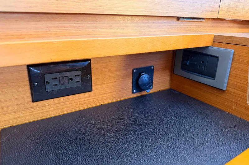 Slide: The Image of Power outlets and control panel on Jeanneau Sun Odyssey 469, 2014 model, wooden interior. - 76