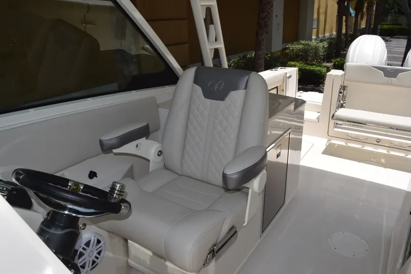 Slide: The Image of The interior of a 2027 Sailfish 276 DC features a luxurious captain's chair and modern helm. - 7