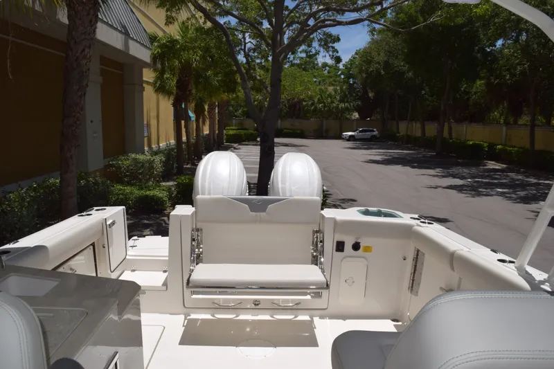 Slide: The Image of 2027 Sailfish 276 DC boat interior with seating and dual outboard motors. - 4