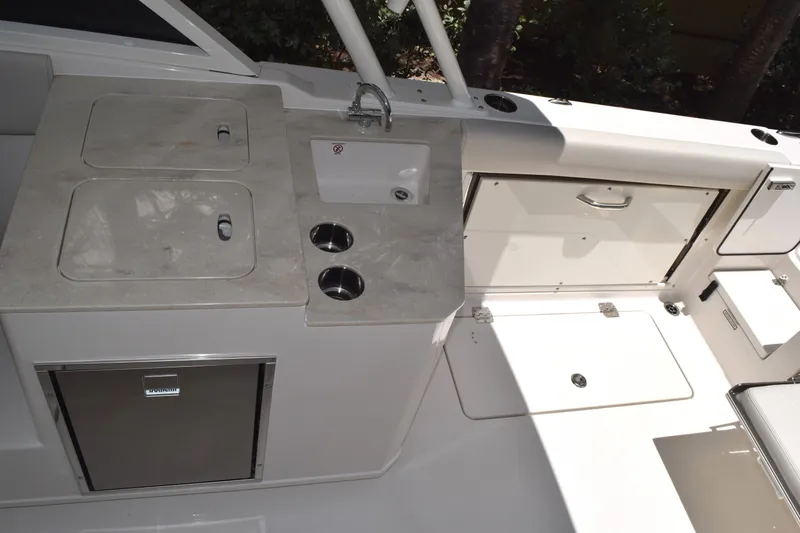 Slide: The Image of The 2027 Sailfish 276 DC features a well-equipped onboard kitchen with a sink and refrigerator. - 11
