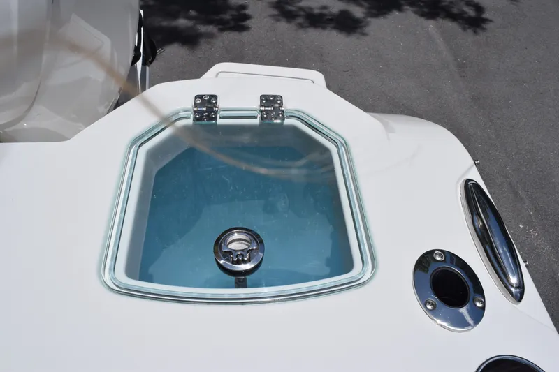 Slide: The Image of Livewell on 2027 Sailfish 276 DC boat, featuring a glass lid and chrome fittings. - 15