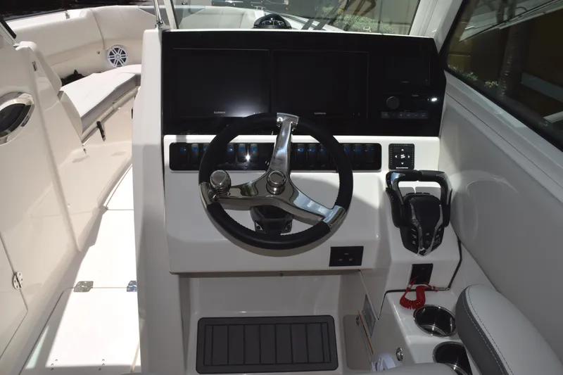 Slide: The Image of 2027 Sailfish 276 DC boat helm with steering wheel and control panel. - 8