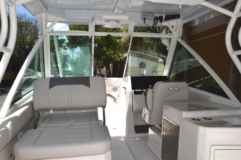 Slide: The Image of The image shows the cockpit of a 2027 Sailfish 276 DC with white upholstery and modern features. - 5