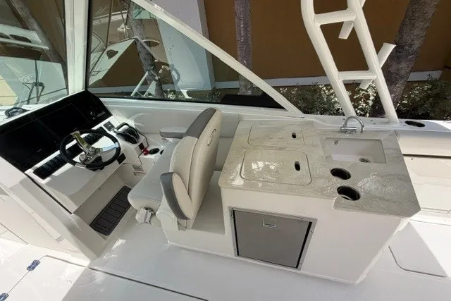 Slide: The Image of Interior of 2027 Sailfish 276 DC boat with helm and kitchenette area. - 10