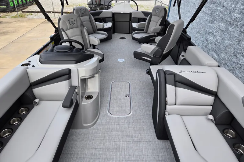 Slide: The Image of The image shows the interior of a 2027 South Bay SS224QC3.0 pontoon boat with gray upholstery and multiple seating areas. - 3