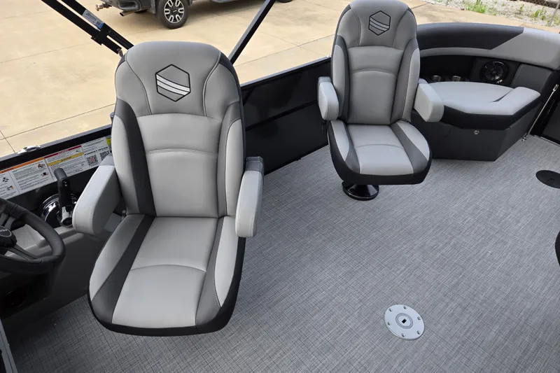 Slide: The Image of Two cushioned captain's chairs in a modern boat with gray carpeting. - 8