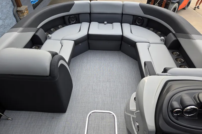 Slide: The Image of The image shows the cockpit of a 2027 South Bay SS224QC3.0 boat with gray upholstery. - 4