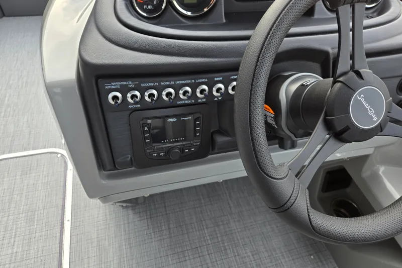 Slide: The Image of The image shows the dashboard of a South Bay SS224QC3.0 boat with various switches and a steering wheel. - 6
