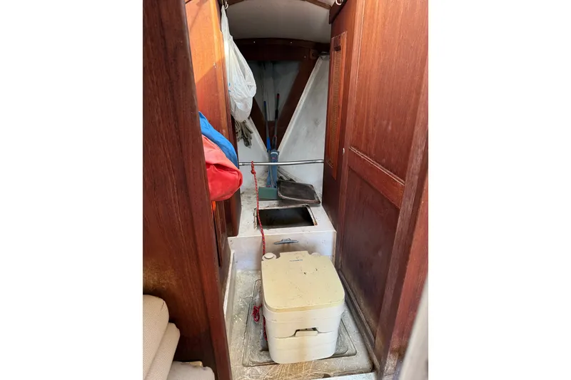 Slide: The Image of Interior of a 1978 Santana 35 sailboat with wooden paneling and storage compartments. - 5