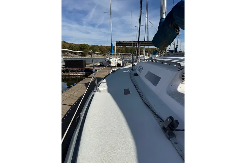 Slide: The Image of 1978 Santana 35 sailboat docked at marina under clear blue sky. - 2