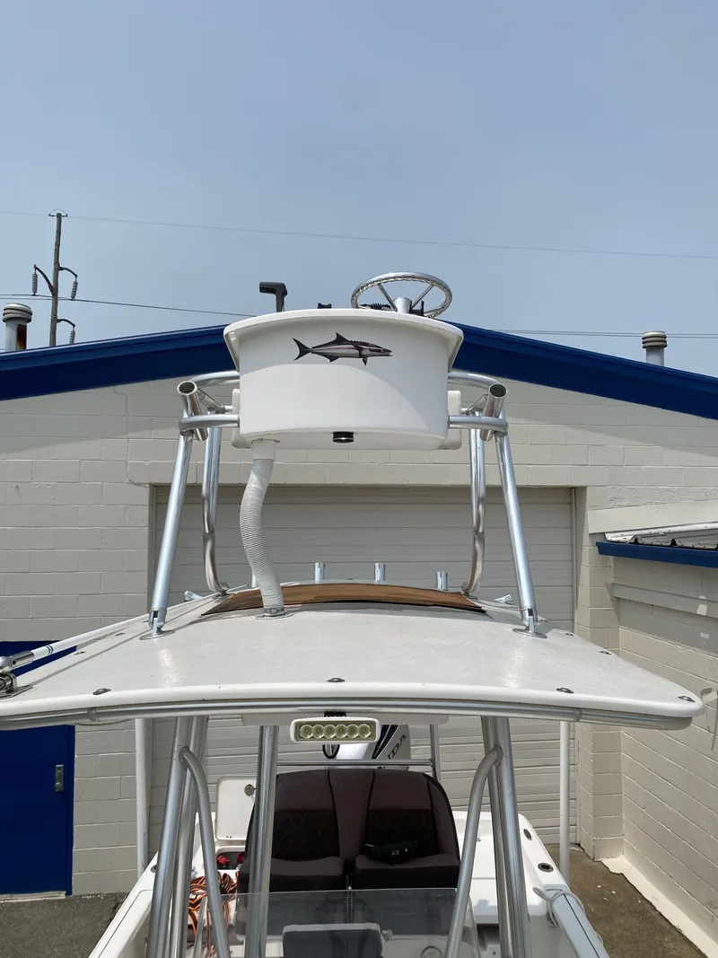 Slide: The Image of A 2018 Tidewater 22 Bay boat with an elevated helm station and a fish logo. - 4