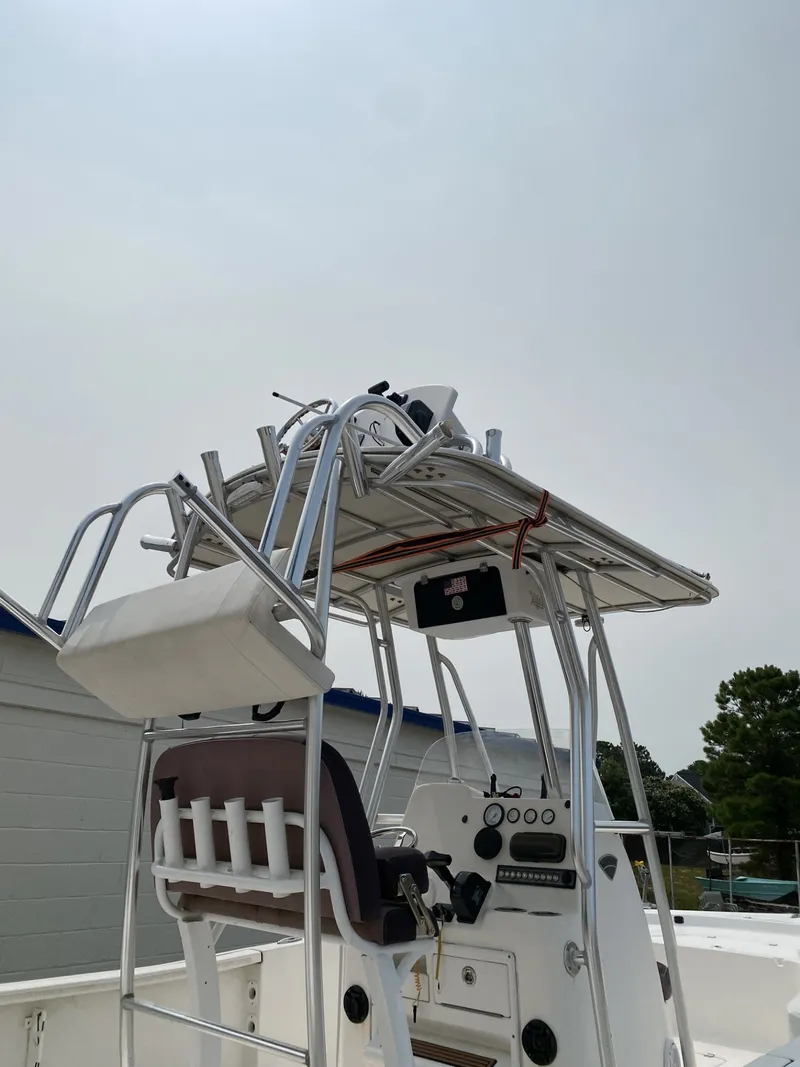 Slide: The Image of A 2018 Tidewater 22 Bay boat featuring a sturdy helm and fishing rod holders. - 1