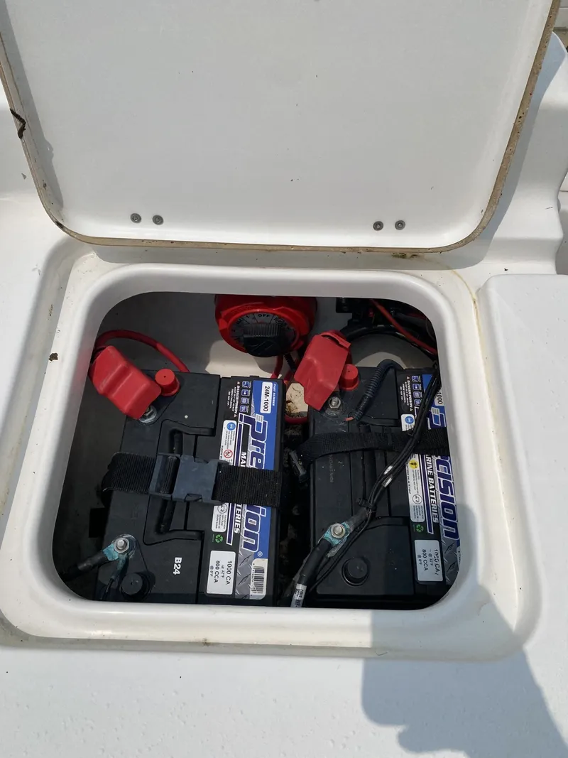 Slide: The Image of Battery compartment of a 2018 Tidewater 22 Bay boat with two batteries and cables. - 7