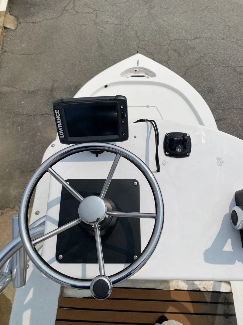 Slide: The Image of The image shows the helm of a 2018 Tidewater 22 Bay boat with a navigation device. - 6